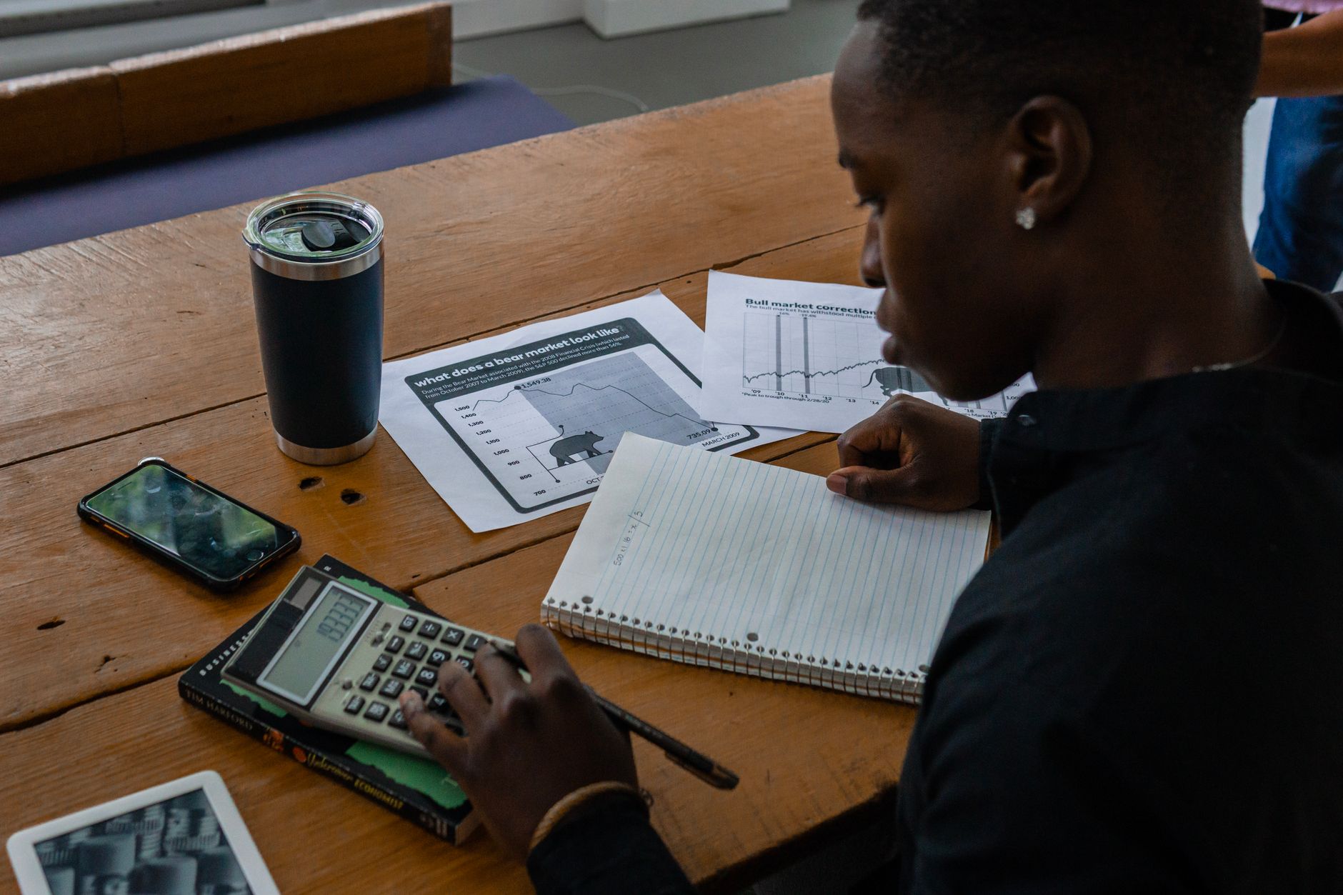 Small business owner reviewing finances to decide between merchant cash advance and business loan
