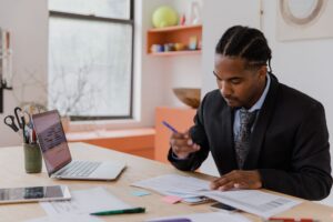 Business owner reviewing financing paperwork at his desk