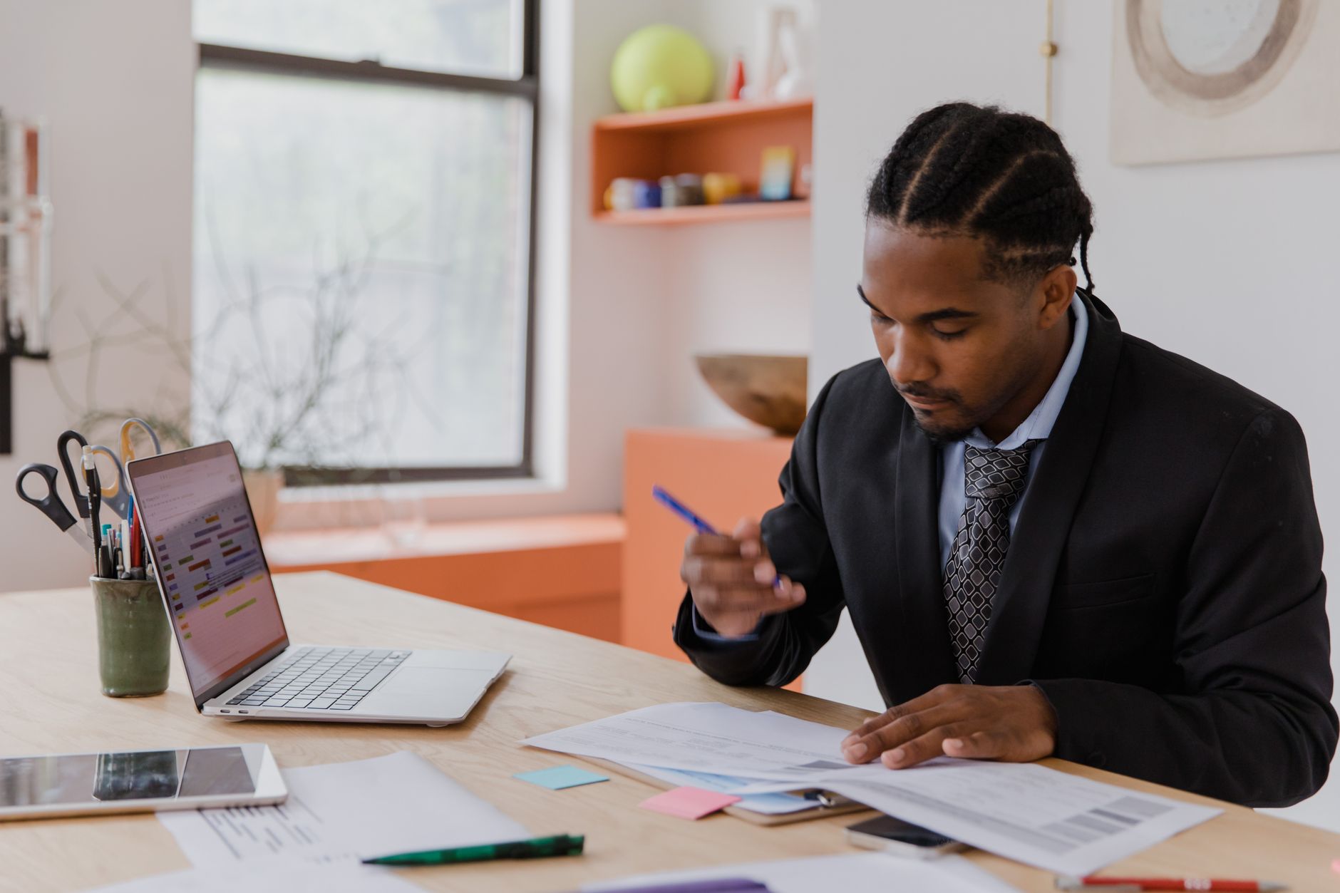 Business owner reviewing financing paperwork at his desk