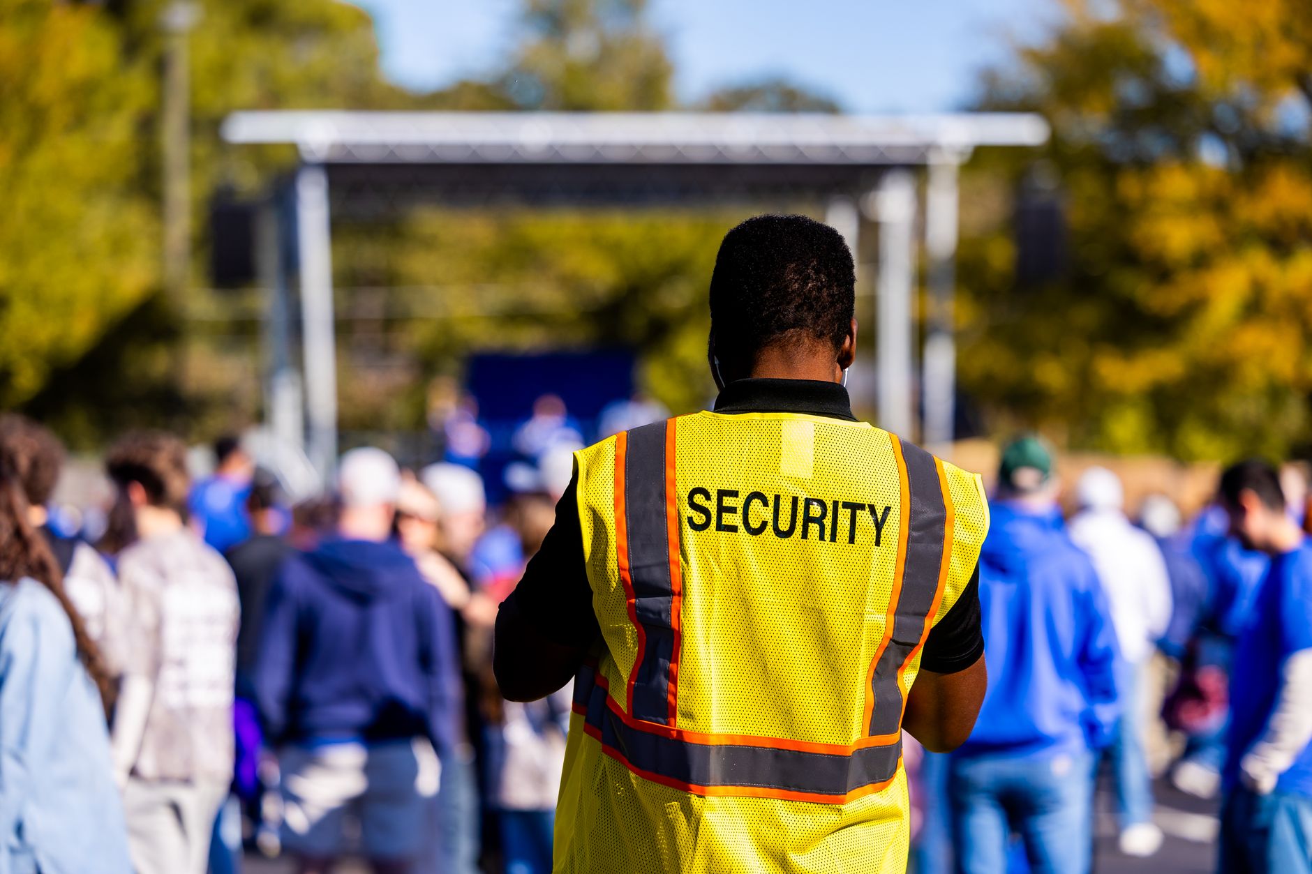 Security guard monitoring a crowd at an outdoor event