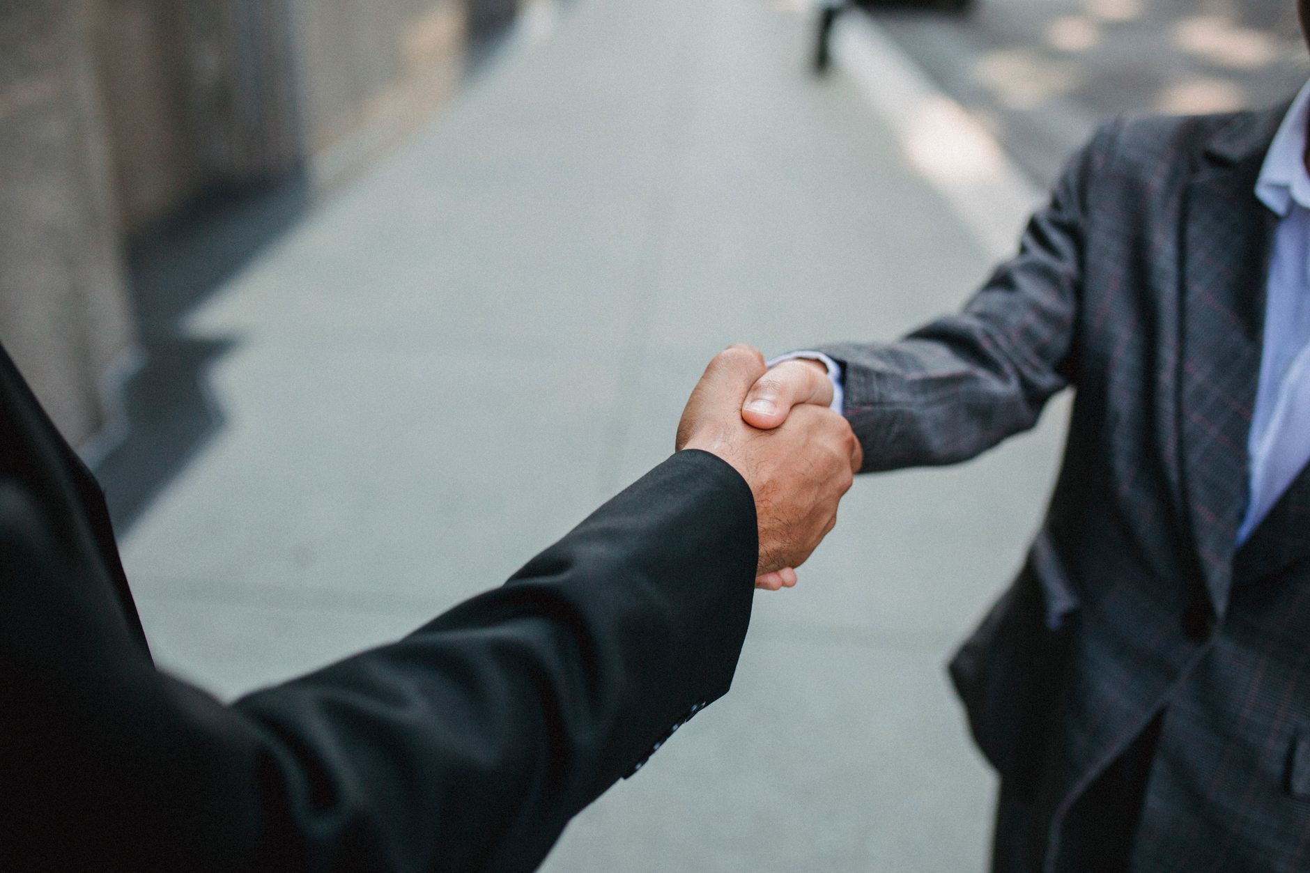 Two business professionals shaking hands symbolizing a transparent funding partnership